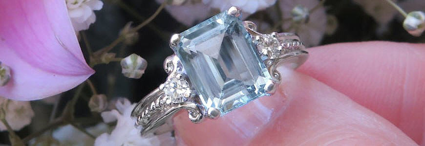 Emerald cut, aquamarine and diamond ring in 14 karat, white gold