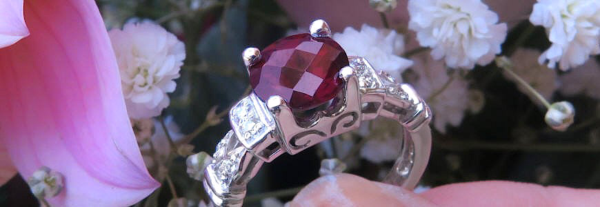 Round checkerboard cut red garnet ring and 14 karat white gold with diamonds