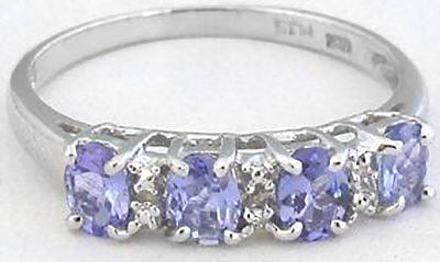 "Stackable oval tanzanite ring in white gold with diamond accents."