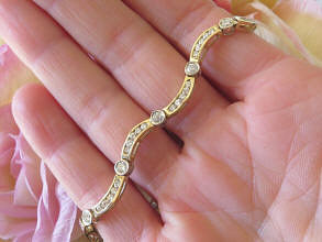 Women's Diamond Bracelet in two tone 14k white and yellow gold with bezel set and channel set diamonds for sale