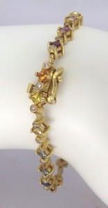 Delicate rainbow sapphire bracelet in 14k white gold featuring vibrant sapphires from Sri Lanka and sparkling diamonds.