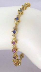 Delicate rainbow sapphire bracelet in 14k white gold featuring vibrant sapphires from Sri Lanka and sparkling diamonds.