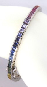 Princess cut rainbow sapphire bracelet in 14k white gold with vibrant natural sapphires and hidden box clasp.