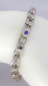 14k white gold bracelet featuring bezel set natural rainbow sapphires, creating a vibrant continuous pattern.