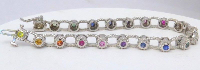 14k white gold bracelet featuring bezel set natural rainbow sapphires, creating a vibrant continuous pattern.