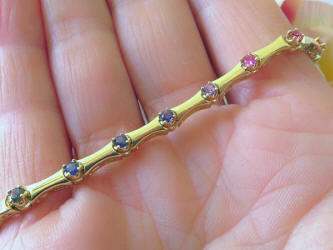 Round cut natural rainbow sapphire tennis bracelet in solid 14k yellow gold for sale