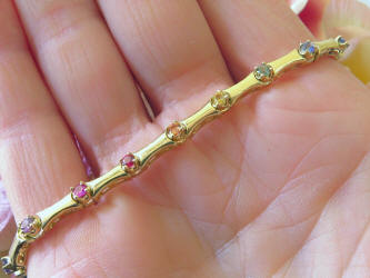 Round cut natural multi color sapphire tennis bracelet in solid 14k yellow gold. 