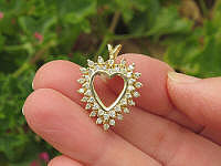 Halo round diamond pendant in gold