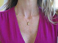 A stunning 0.50 carat Princess Cut Diamond Solitaire Necklace in 14k yellow gold.