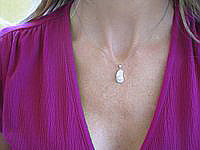 A charming 0.32 ctw diamond sandal pendant in 14k white gold.