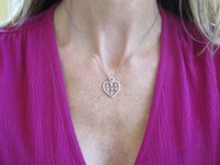 A sparkling diamond heart pendant in 14k white gold.