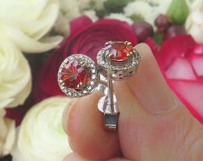 Natural red orange sapphire and diamond halo stud earrings in 14 white gold
