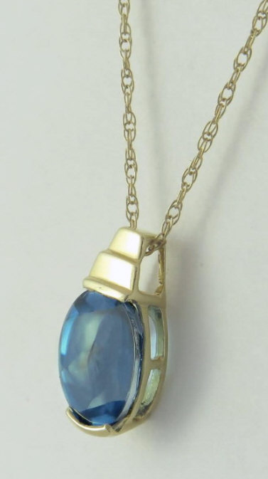 Buff Top Blue Topaz Pendant in 14k gold 