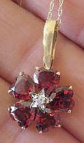 Garnet Flower Necklaces with Diamond Star accent in yellow gold