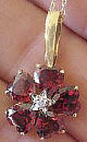 Garnet Flower Necklace with Diamond accent in 14k yellow gold