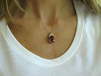Shimmering pink tourmaline pendant with diamonds in 14k white gold.