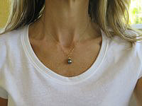 A sleek 14k gold pendant with natural Tahitian pearls in a stair step design.