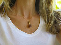 A stunning Cognac Tourmaline and Diamond Pendant in 14k yellow gold setting.