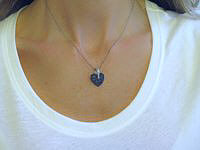 A heart-shaped pendant with pave sapphire and diamond accents on black rhodium setting.