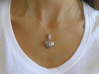 A stunning heart pendant with rainbow sapphires and diamonds in 14k white gold, showcasing vibrant colors and exquisite craftsmanship.