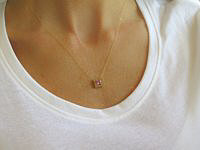 Pink sapphire pendant in 14k yellow gold with princess cut Ceylon sapphire and sparkling diamonds.