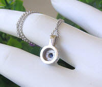 Back of round blue sapphire necklace in 14k white gold