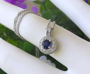 Round Natural Blue Sapphire Pendant Necklace with a Diamond Halo set in 14k white gold for sale