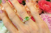 A stunning green gemstone ring featuring a large 8mm checkerboard cut peridot set in elegant 14k yellow gold.