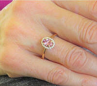 Ceylon Oval Natural Pink Sapphire Ring in 14k Rose Gold with Diamond Halo shown on hand