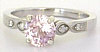 Delicate pink sapphire ring with diamond accents in 14k white gold.