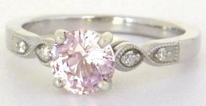 Delicate pink sapphire ring with diamond accents in 14k white gold.