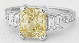 Unheated yellow sapphire engagement ring in 18k white gold with radiant cut and vintage style baguette and round diamonds.