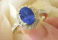 Buy a Natural Untreated Oval Blue Sapphire and Real Diamond Halo Ring in solid 14k yellow gold