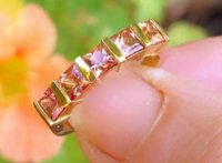 Vibrant ombre orange peach sapphire ring in 14k yellow gold.