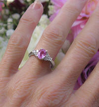 Natural Oval Cut Pink Sapphire Ring with real side diamonds in a plain solid 14k white gold band for sale