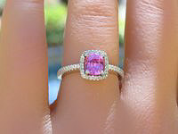 Vibrant hot pink sapphire ring with diamond halo in elegant 14k white gold setting.
