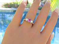 A stunning princess cut pink sapphire ring with sparkling diamonds in 14k white gold.