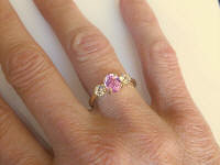 Classic Oval Natural Oval Pink Sapphire Engagement Ring with Round White Sapphires set in 14k yellow gold for sale