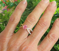 Cushion-oval natural pink sapphire in split shank setting with fine diamonds in 14k rose gold