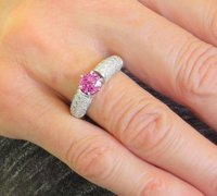 Shimmering pink sapphire ring with pave diamonds in 18k white gold, exuding elegance and femininity.