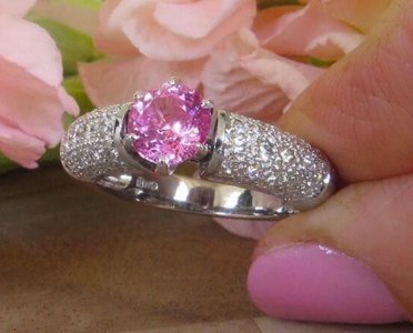 A stunning pink sapphire ring with pave diamonds in 18k white gold, exuding elegance and femininity.