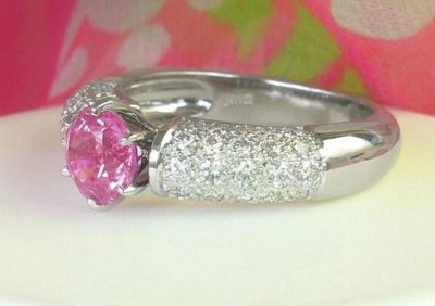A stunning pink sapphire ring with pave diamonds in 18k white gold, exuding elegance and femininity.