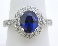 Cornflower blue Ceylon sapphire ring with a scalloped diamond halo set in platinum, featuring a low-profile design.