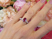 Elegant oval Burmese ruby engagement ring with diamonds in white gold.