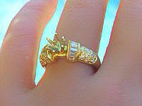 A stunning 14k yellow gold ring with baguette and round diamonds, totaling a full carat.
