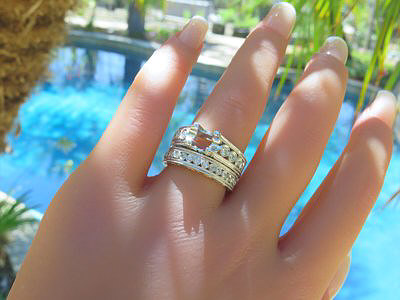 Elegantly designed round diamond engagement ring and matching band in 18k white gold with intricate detailing.