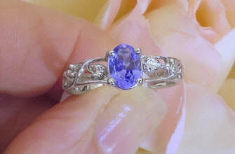 Solitaire tanzanite band ring in 14k white gold
