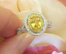 Buy a Unique Natural Oval Yellow Sapphire Engagement Ring and Band Set with a Double Diamond and Sapphire Halo in a split shank 14k white and yellow gold mounting