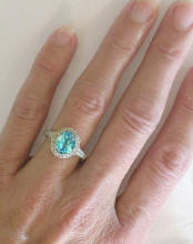 Oval Blue Topaz Diamond Halo Ring in 14k white gold
