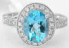 Oval Swiss Blue Topaz and Diamond Halo Engagement Ring in 14k white gold